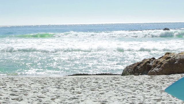 A woman is running down a pristine sandy beach, carrying a surfboard, with the sparkling ocean waves in the background. Ideal for content related to outdoor activities, beach holidays, surfing, and coastal adventures. Suitable for travel blogs, tourism promotions, fitness and lifestyle marketing.