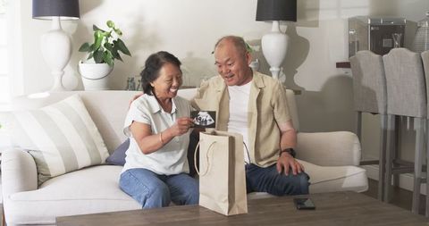 Grandparents Discover Pregnancy News in Gift Packaging