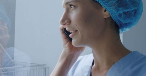 Caucasian female doctor in surgical cap talking on phone