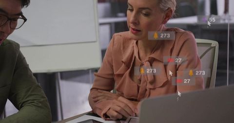 Collaborative team analyzing dashboard metrics with notification overlays on tablet and laptop
