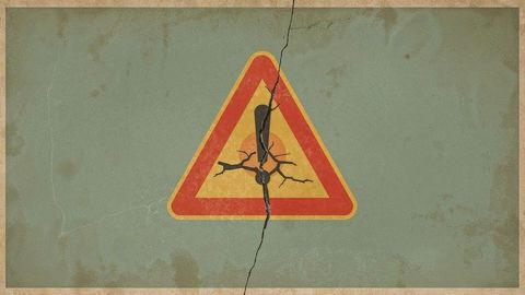 Earthquake cracked panel with hazard sign illustrating warning