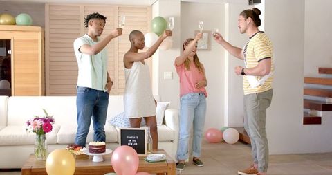 Friends toasting new job celebration with champagne and cake