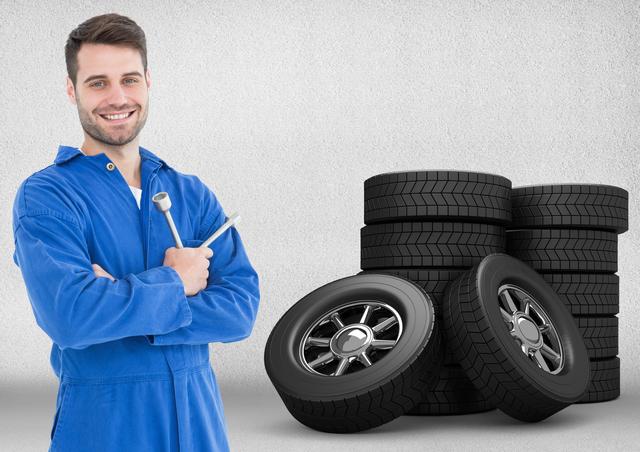 Digital composite image of mechanic holding lug wrench and standing next to tyres