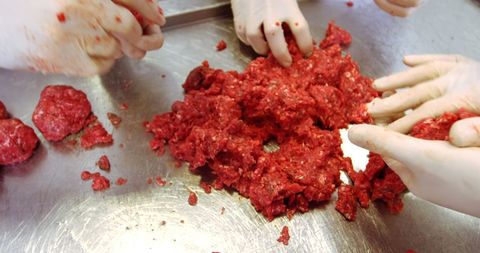 Butchers preparing minced meat in a butcher shop