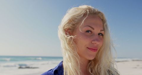 Smiling Woman Enjoying Sunny Day on Tranquil Beach - Download Free Stock Images Pikwizard.com