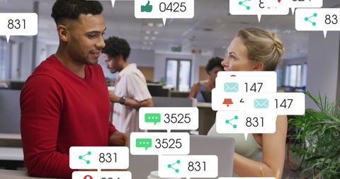 Diverse Colleagues Analyzing Social Media Notifications in Modern Office