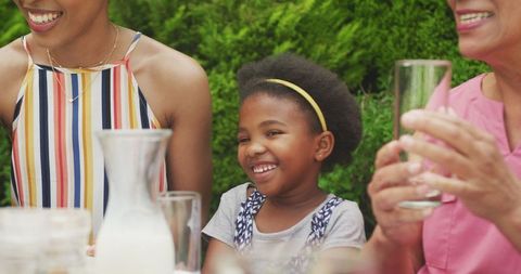 Happy Multigenerational Family Enjoying Outdoor Garden Breakfast