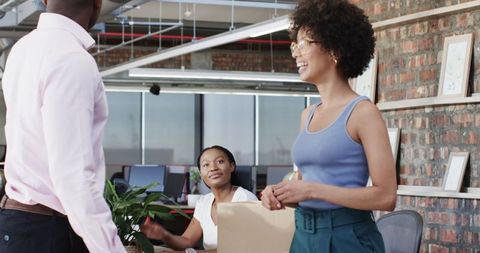 Diverse Team Collaboration and Unboxing in Modern Office