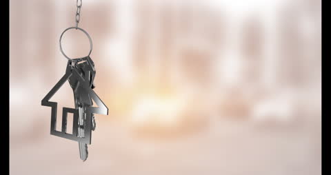 House-Shaped Keychain with Key Over Blurred Background