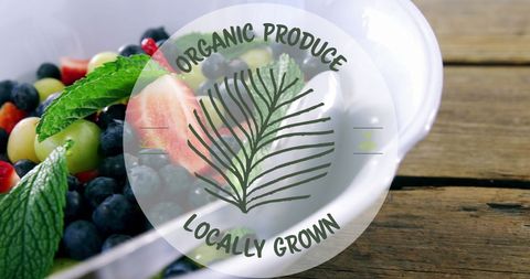 Organic produce badge on fresh fruit salad on wooden table