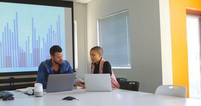 Colleagues Analyzing Data on Laptops in Modern Office Conference Room - Download Free Stock Images Pikwizard.com