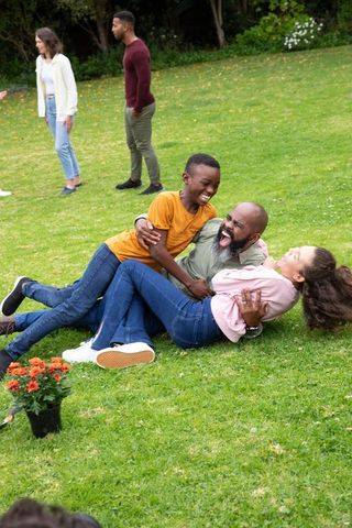 Joyful Family Bonding on Lawn with Lush Greenery