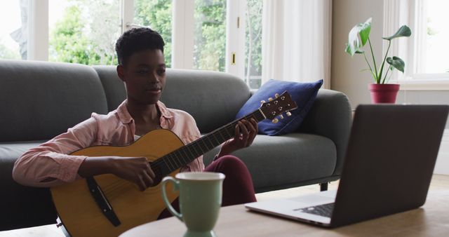 Woman Playing Acoustic Guitar While Attending Online Music Class - Download Free Stock Images Pikwizard.com