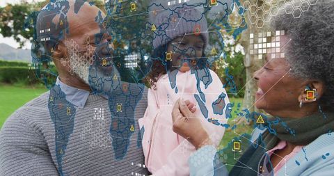 Senior couple holding grandchild in park, digital map overlay showing global connection