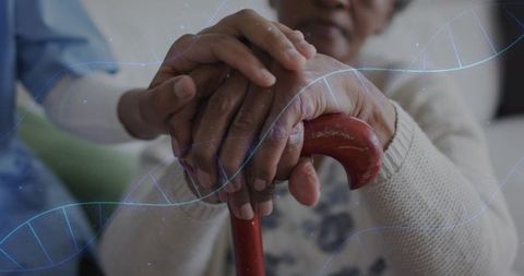 Elderly hands holding cane receiving caregiver support with dna helix overlay