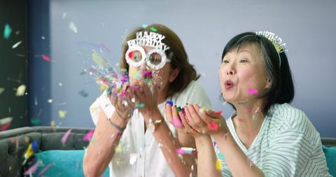 Senior Friends Celebrating a Joyous Birthday with Confetti at Home