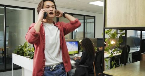 Busy Open Office with Young Professionals Collaborating