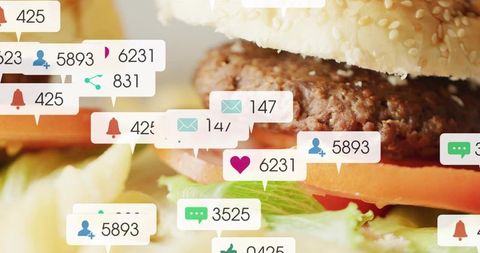 Sesame burger with beef patty, tomato and lettuce with social media notification overlays