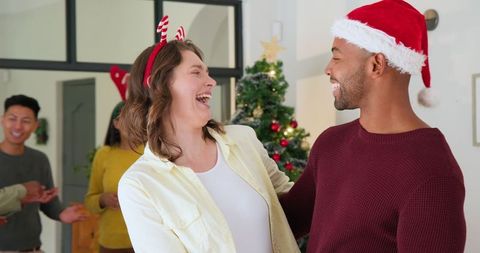 Festive Friends Embracing During Christmas at Home