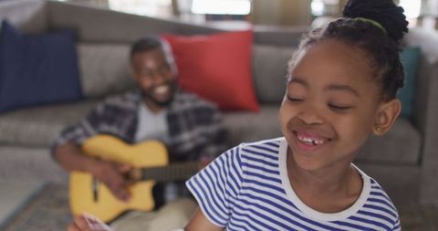 Happy Family: Daughter Dancing, Father Playing Guitar