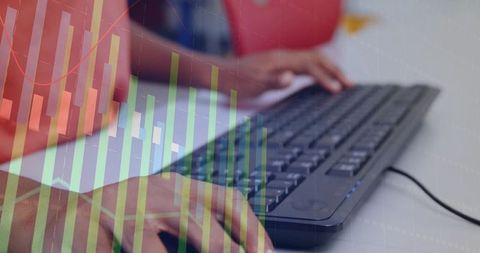 Child typing on wired keyboard with financial chart overlay for online learning analytics