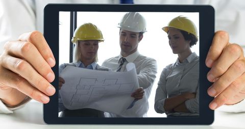Architect Discussing Blueprints on Tablet with Diverse Team - Download Free Stock Images Pikwizard.com