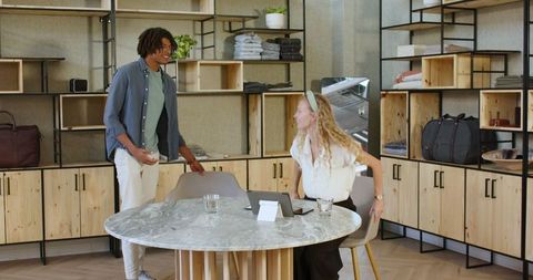 Colleagues Collaborating in Modern Office with Digital Devices