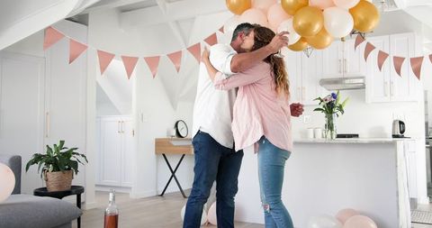 Couple Celebrating Engagement with Wine in Decorated Home