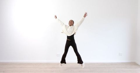 Energetic Dance in Minimalist Room Conveying Joy and Freedom