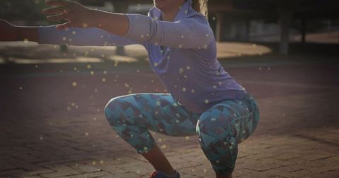 Outdoor squat workout golden hour patterned leggings purple top sunlit bokeh