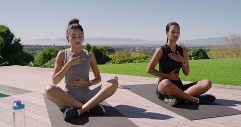 Diverse Women Engaging in Outdoor Meditation for Mindfulness and Relaxation