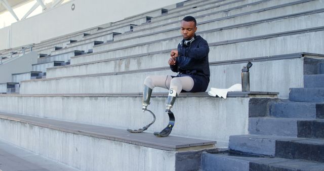 Adaptive Athlete with Prosthetic Legs Preparing for Training in Stadium - Download Free Stock Images Pikwizard.com