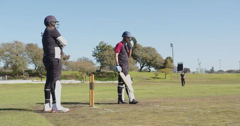 Cricket Players Preparing for Match on Outdoor Field
