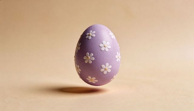 Floating lavender easter egg with white daisy motifs casting soft shadow on beige