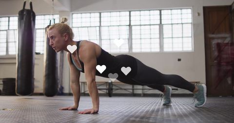 Fit Woman in Plank Position at Gym with Digital Overlay