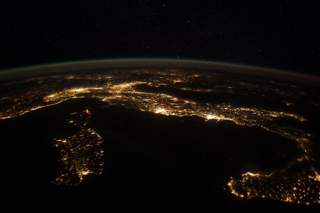 This photo shows striking nighttime illumination of Europe, photographed from aboard the International Space Station at 240 miles altitude near the Tyrrhenian Sea on January 25, 2012. Italy features prominently with visible lights from major cities including Rome and Naples. Nearby islands Sardinia and Corsica appear at lower left, and Sicily at lower right. This image captures the Adriatic Sea to the east and outlines connecting parts of neighboring European countries. Ideal for geography, space exploration, and city light pollution studies.