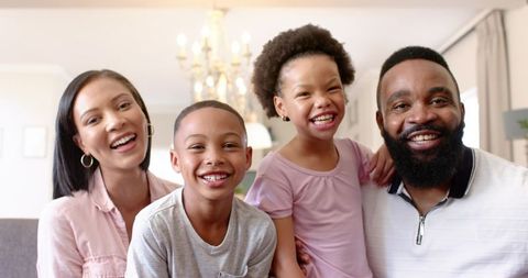 Happy African American Family Smiling Together in Cozy Living Room