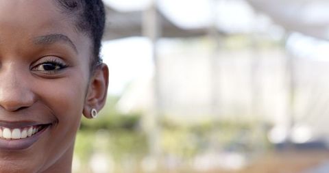 Cheerful Woman Smiling at Botanical Garden with Nature in Background