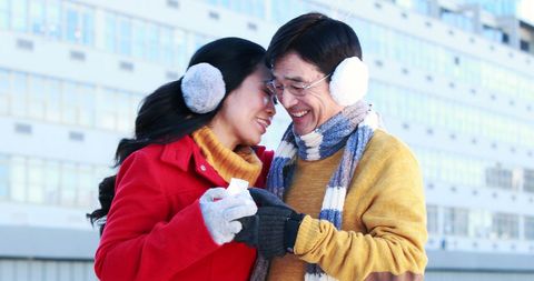 Middle-aged couple sharing joyful moment in winter