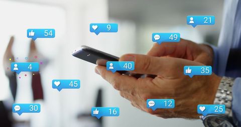 Businessman using smartphone with social media icons float