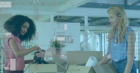 Businesswomen Unpacking Boxes with Financial Data Overlay