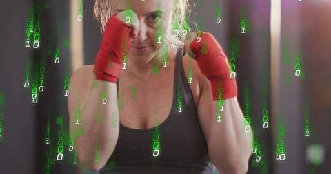 Female boxer training and throwing punches with red hand wraps, green binary tech overlay