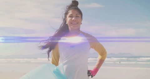 Smiling woman volunteering in beach clean-up