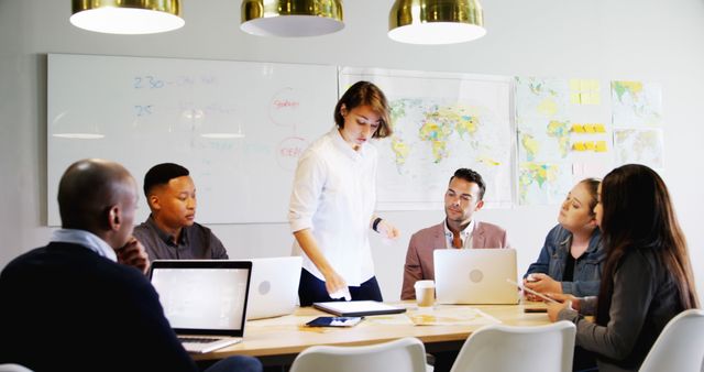 Diverse Team Collaborating in Modern Office with World Maps on Walls - Download Free Stock Images Pikwizard.com