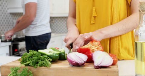 Young Woman Preparing Vegetables in Modern Kitchen