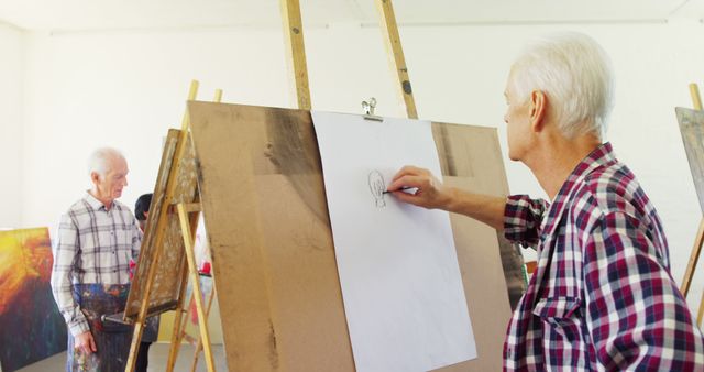 Senior Man Drawing on Easel in Art Class - Download Free Stock Images Pikwizard.com