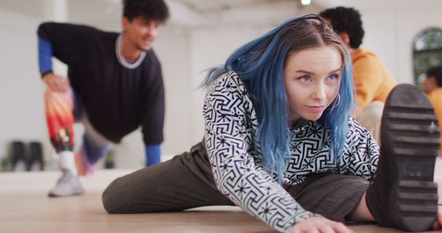 Young Woman with Blue Hair Stretching During Dance Practice - Download Free Stock Images Pikwizard.com