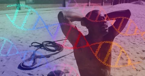 Tired athlete at beach with colorful dna overlay