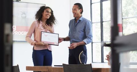Diverse colleagues celebrating recognition in office