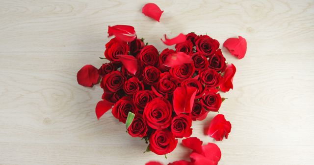 Petals falling over red roses in heart shape formation - Download Free Stock Photos Pikwizard.com